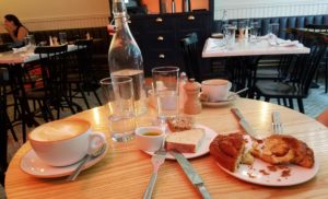 Latte, cappuccino, bread and cinnamon danish from Kirsh